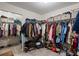Large walk-in closet features ample hanging space and shelving for storage at 543 Walnut Way, Palmetto, GA 30268