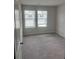 Cozy bedroom with plush carpet and two windows at 6426 Rosetta Drive # 53, South Fulton, GA 30331