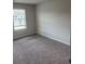 Bedroom with plush carpet and large window at 6426 Rosetta Drive # 53, South Fulton, GA 30331