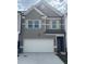 Charming townhome featuring a two-car garage and stylish gray siding at 6426 Rosetta Drive # 53, South Fulton, GA 30331