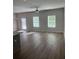 Open living room featuring wood-look flooring, ceiling fan, and natural light from the windows at 6426 Rosetta Drive # 53, South Fulton, GA 30331