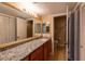 Bathroom with a granite countertop, a large mirror, vanity cabinet, and tile floors at 177 Nw Amherst Pl, Atlanta, GA 30327