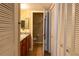 This bathroom features a granite countertop, vanity cabinet, tile floors, and a closet for ample storage at 177 Nw Amherst Pl, Atlanta, GA 30327