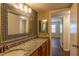 Bathroom featuring a granite countertop vanity with custom framed mirror and modern lighting at 177 Nw Amherst Pl, Atlanta, GA 30327