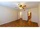 Spacious bedroom showcasing neutral walls, wood floors, fan, and an ensuite bath at 177 Nw Amherst Pl, Atlanta, GA 30327