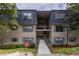 Inviting exterior of multi-level condo building with blue shutters and well-maintained landscaping at 177 Nw Amherst Pl, Atlanta, GA 30327
