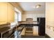 Bright kitchen with white cabinets, granite countertops, and stainless steel appliances at 177 Nw Amherst Pl, Atlanta, GA 30327