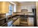 Bright kitchen featuring granite countertops, stainless steel appliances, and tile backsplash at 177 Nw Amherst Pl, Atlanta, GA 30327