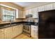Kitchen featuring stainless steel appliances, tile floors, dark countertops, and bright cabinets at 177 Nw Amherst Pl, Atlanta, GA 30327