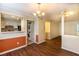 Open-concept living room with wood floors, modern lighting, and adjacent in-unit laundry at 177 Nw Amherst Pl, Atlanta, GA 30327