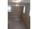 Unfinished basement offers potential with natural light from two windows at 2598 Miriam Ln, Decatur, GA 30032
