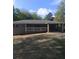 A single story home with a white picket fence, attached carport and green lawn at 2598 Miriam Ln, Decatur, GA 30032