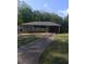 A single story home with a white picket fence, attached carport and long driveway at 2598 Miriam Ln, Decatur, GA 30032
