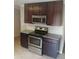 A kitchen with stainless steel appliances, dark wood cabinets, and granite countertops at 2598 Miriam Ln, Decatur, GA 30032