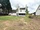 Spacious backyard with a well-maintained lawn and an enclosed sunroom attached to the house at 3058 Arden Ridge Ter, Suwanee, GA 30024