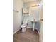 Compact bathroom featuring a sleek pedestal sink and toilet, ideal for guest use at 3058 Arden Ridge Ter, Suwanee, GA 30024