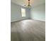 Light and airy bedroom with modern light fixture and large window at 3058 Arden Ridge Ter, Suwanee, GA 30024
