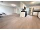 A sun-filled living room flows into an open kitchen with modern appliances and granite countertops at 3058 Arden Ridge Ter, Suwanee, GA 30024