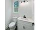 Well-lit bathroom with a modern vanity, sink, and fixtures at 5215 Virginia Ave, Cumming, GA 30041