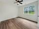 Bright, modern bedroom with luxury vinyl flooring, large window, and white walls at 5215 Virginia Ave, Cumming, GA 30041