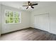 Bedroom with natural light through the window and a double closet at 5215 Virginia Ave, Cumming, GA 30041