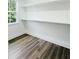 Bright pantry features sleek wood-look floors and built-in shelving for ample storage at 5215 Virginia Ave, Cumming, GA 30041