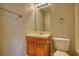 Bathroom features a sink and vanity with a wooden base and a white toilet at 5587 Strathmoor Manor Cir, Lithonia, GA 30058