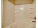 Bathtub and shower features a white interior and storage shelving at 5587 Strathmoor Manor Cir, Lithonia, GA 30058