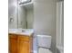 A modern bathroom featuring a vanity with a sleek countertop, mirror and fixtures at 5587 Strathmoor Manor Cir, Lithonia, GA 30058