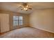Bedroom with large window and neutral carpet providing comfortable and open space at 5587 Strathmoor Manor Cir, Lithonia, GA 30058