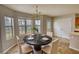Bright dining area with a chandelier and table set for four at 5587 Strathmoor Manor Cir, Lithonia, GA 30058