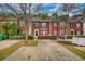 Charming red brick townhomes with lush landscaping and inviting curb appeal at 5587 Strathmoor Manor Cir, Lithonia, GA 30058