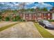 Charming brick townhomes featuring landscaped front yards and a paved parking space at 5587 Strathmoor Manor Cir, Lithonia, GA 30058