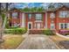 Charming brick townhome with well-maintained landscaping around the entrance at 5587 Strathmoor Manor Cir, Lithonia, GA 30058