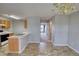 Open kitchen with eat-at counter and view to foyer at 5587 Strathmoor Manor Cir, Lithonia, GA 30058