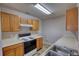 Well-lit kitchen with wooden cabinets and modern stove-top at 5587 Strathmoor Manor Cir, Lithonia, GA 30058