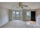 Bright living room featuring neutral carpet, and front door access at 5587 Strathmoor Manor Cir, Lithonia, GA 30058