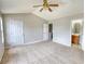 Large carpeted main bedroom boasts a vaulted ceiling, bathroom entry and large closet at 5587 Strathmoor Manor Cir, Lithonia, GA 30058