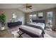 A cozy main bedroom featuring a large window and modern décor at 5587 Strathmoor Manor Cir, Lithonia, GA 30058