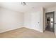 Bedroom boasts neutral walls, tan carpet, and view to the kitchen at 1080 Abington Ct, Douglasville, GA 30134