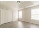 Bedroom featuring gray laminate flooring, a ceiling fan, and large windows at 1080 Abington Ct, Douglasville, GA 30134