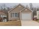 Charming home featuring a one-car garage and a well-maintained lawn at 1080 Abington Ct, Douglasville, GA 30134