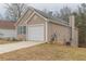 Charming home featuring a one-car garage and a well-maintained lawn at 1080 Abington Ct, Douglasville, GA 30134