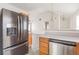 Eat-in kitchen featuring stainless appliances, wood cabinets and open view to the living room at 1080 Abington Ct, Douglasville, GA 30134