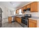 Galley kitchen featuring stainless appliances, wood cabinets and open view to the living room at 1080 Abington Ct, Douglasville, GA 30134