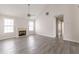 Bright living room with fireplace, large windows, high ceilings, and modern gray laminate flooring at 1080 Abington Ct, Douglasville, GA 30134