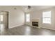 Bright living room showcasing the fireplace, large windows, and modern gray laminate flooring at 1080 Abington Ct, Douglasville, GA 30134