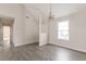 Bright living room with vaulted ceilings, gray vinyl floors and natural light from a large window at 1080 Abington Ct, Douglasville, GA 30134