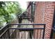 Apartment balcony overlooking the neighborhood and featuring brick wall accents at 319 Atlanta Se St # 317, Marietta, GA 30060