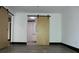 Bedroom with wood-look floors features a modern sliding barn door leading to bathroom at 319 Atlanta Se St # 317, Marietta, GA 30060